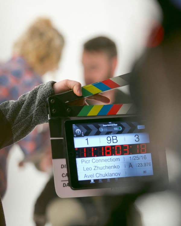 A film crew calling a take on a clapperboard.